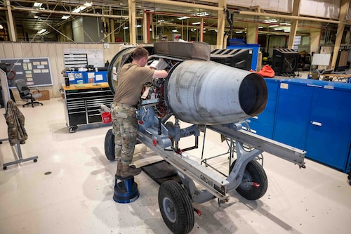 An Airman performs maintenance on a A-10 engine.
