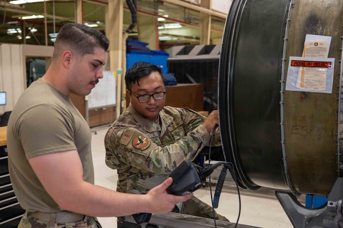 Airmen perform maintenance on a A-10 engine.