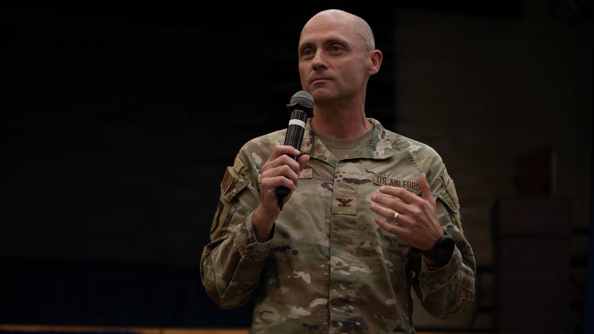 A commander speaks during a town hall.