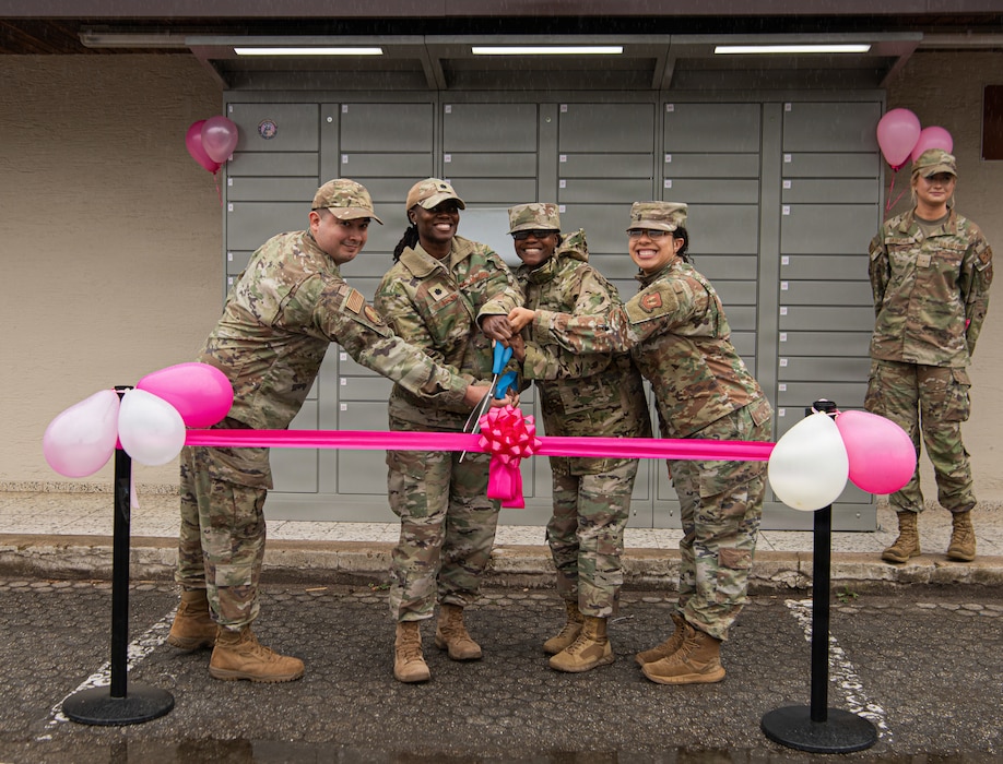 people cut a ribbon for a ceremony