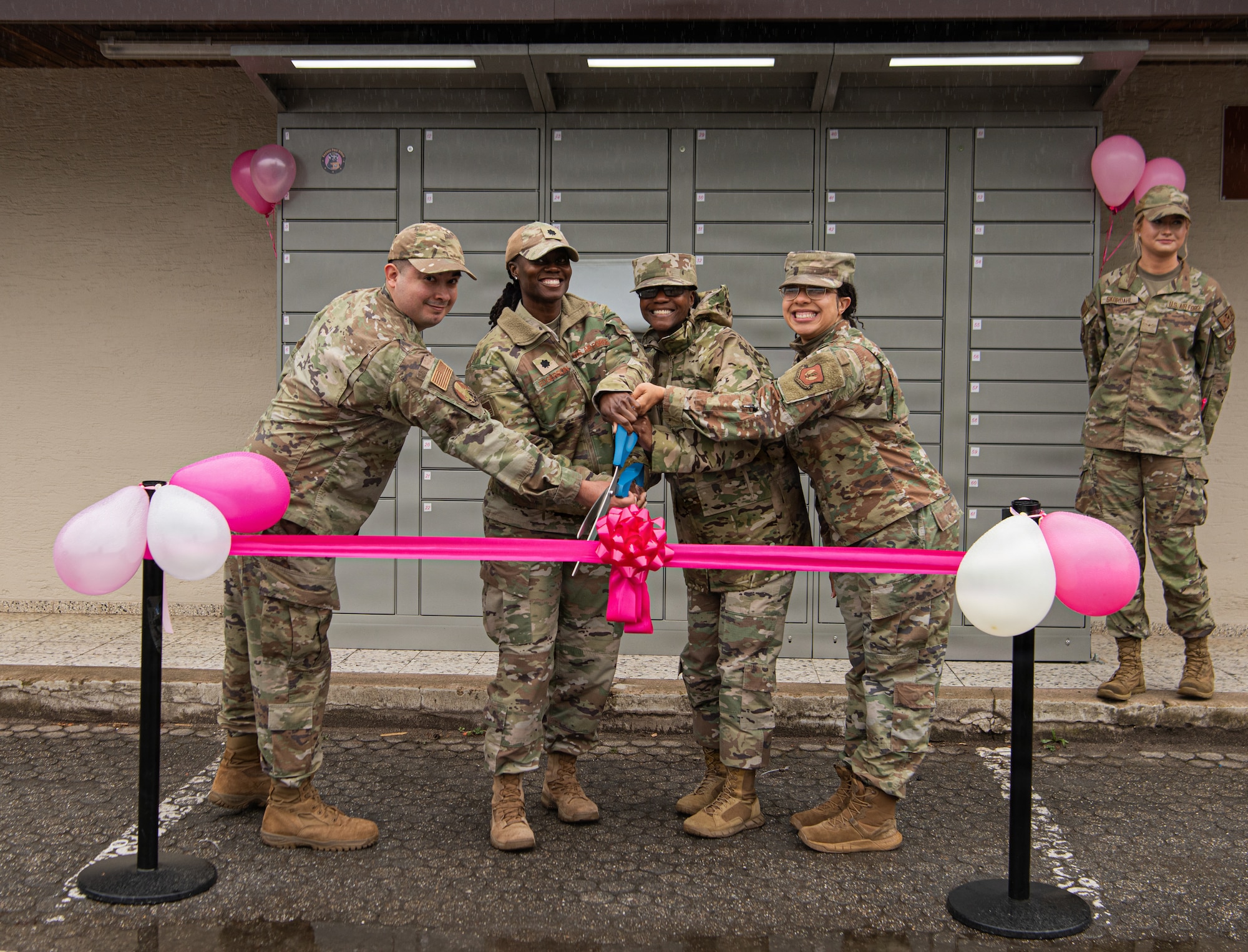 people cut a ribbon for a ceremony
