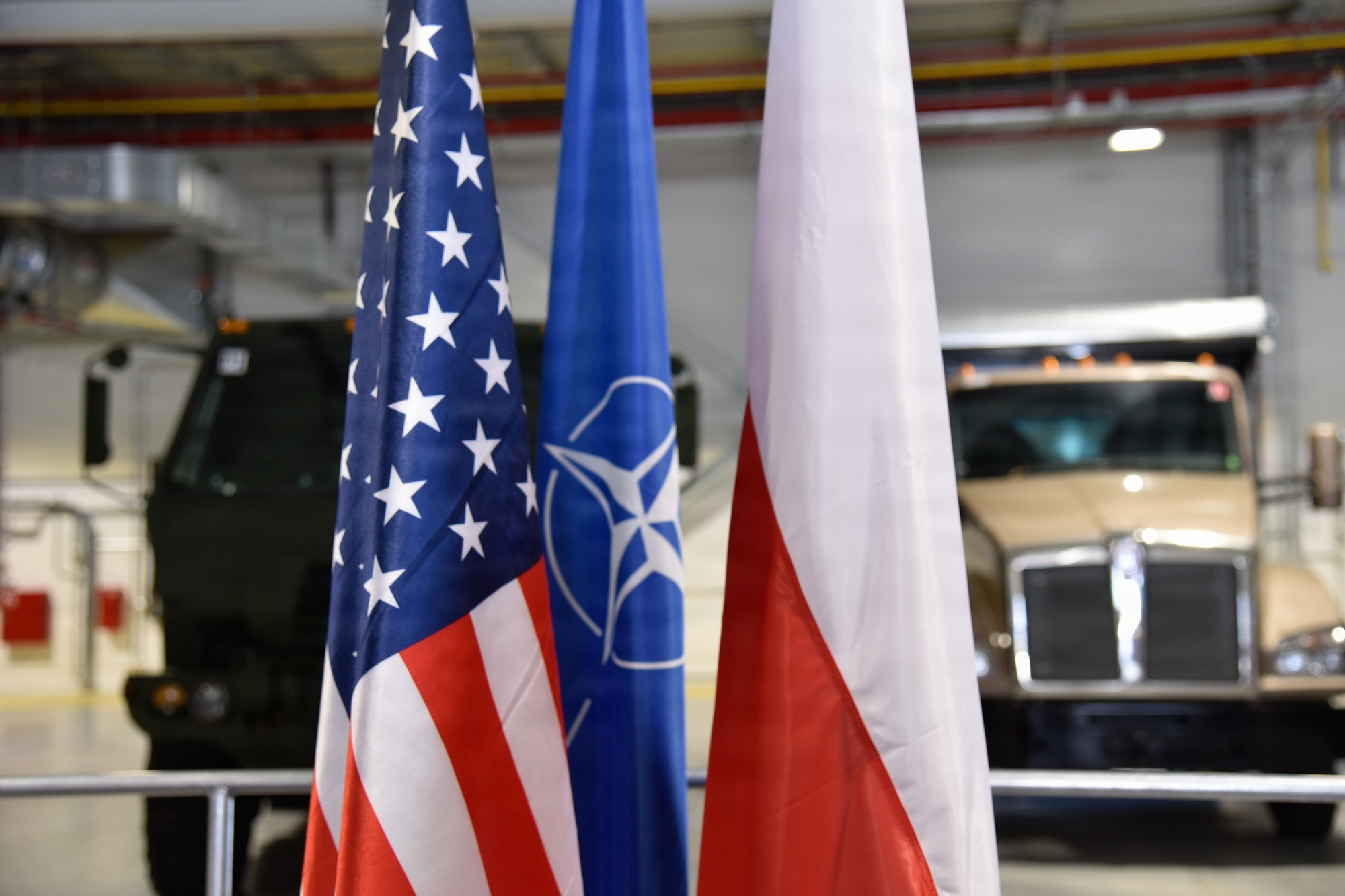 U.S. flag, NATO flag, and Poland flag