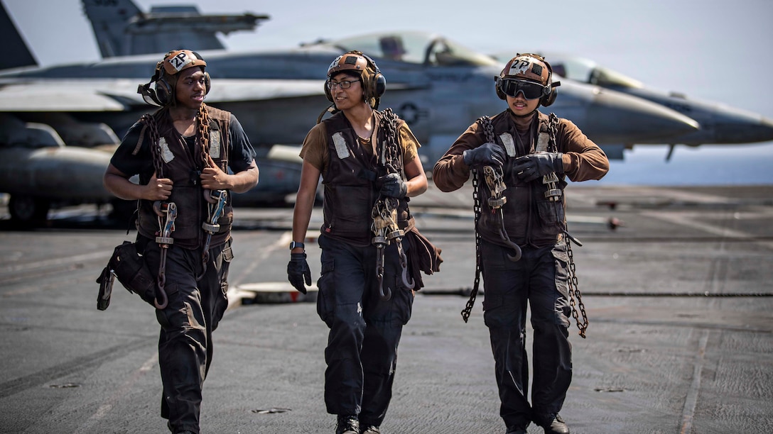 U.S. Sailors carry chocks and chains on the flight deck of Nimitz-class aircraft carrier USS Abraham Lincoln (CVN 72), May 24, 2026. Abraham Lincoln is deployed to the U.S. 5th Fleet area of operations to support maritime security and stability in the Middle East. (U.S. Navy photo)