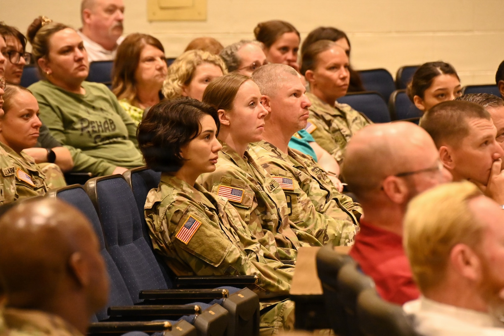 The audience sits, intently focusing on the commander's testimony about the day he was the victim of an active shooter.