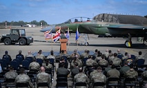 The Opeeration El Dorado 40th Anniversary paint schemed F15-E Strike eagle is rolled out in front of an appluading crowd.