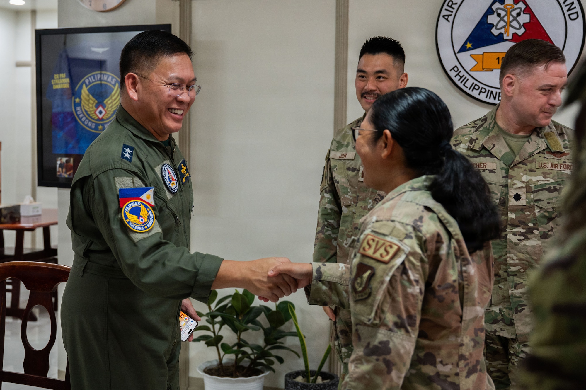 Philippine Air Force Maj. Gen. Dennis Estrella, Air Logistics Command commander, shakes hands with U.S. Air Force Airman 1st Class Jamie Bhel Archuleta, 7th Force Support Squadron food service technician, during a subject-matter expert exchange at Clark Air Base, Philippines, May 8, 2026. Balikatan is a longstanding annual exercise between the Armed Forces of the Philippines and U.S. military designed to strengthen our ironclad alliance, improve our capable combined force and demonstrate our commitment to regional security and stability. (U.S. Air Force photo by Senior Airman Alondra Cristobal Hernandez)