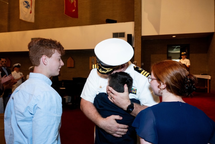 A photo of a man hugging his son.