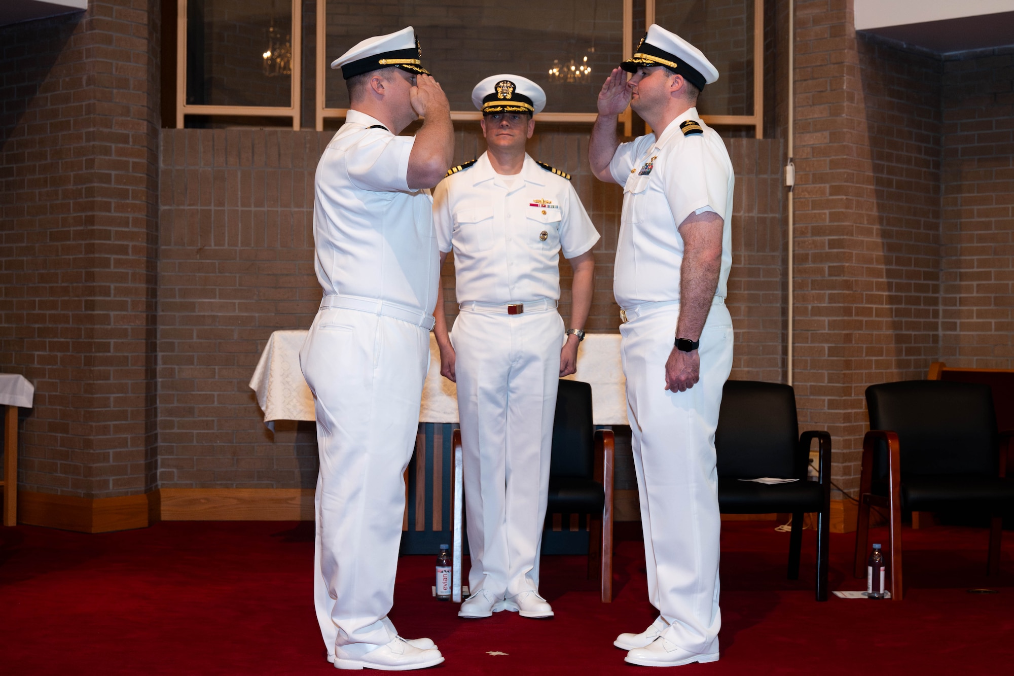 A photo of two men saluting each other.