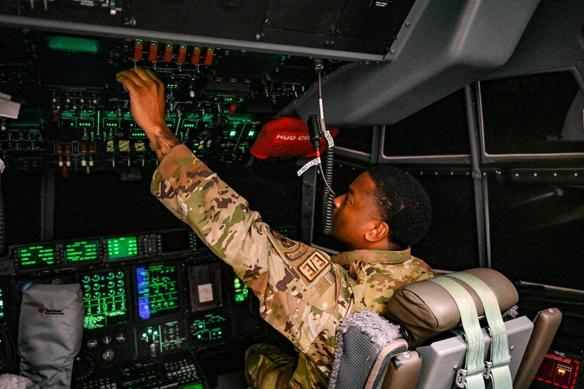 Man pushes buttons in C-130.