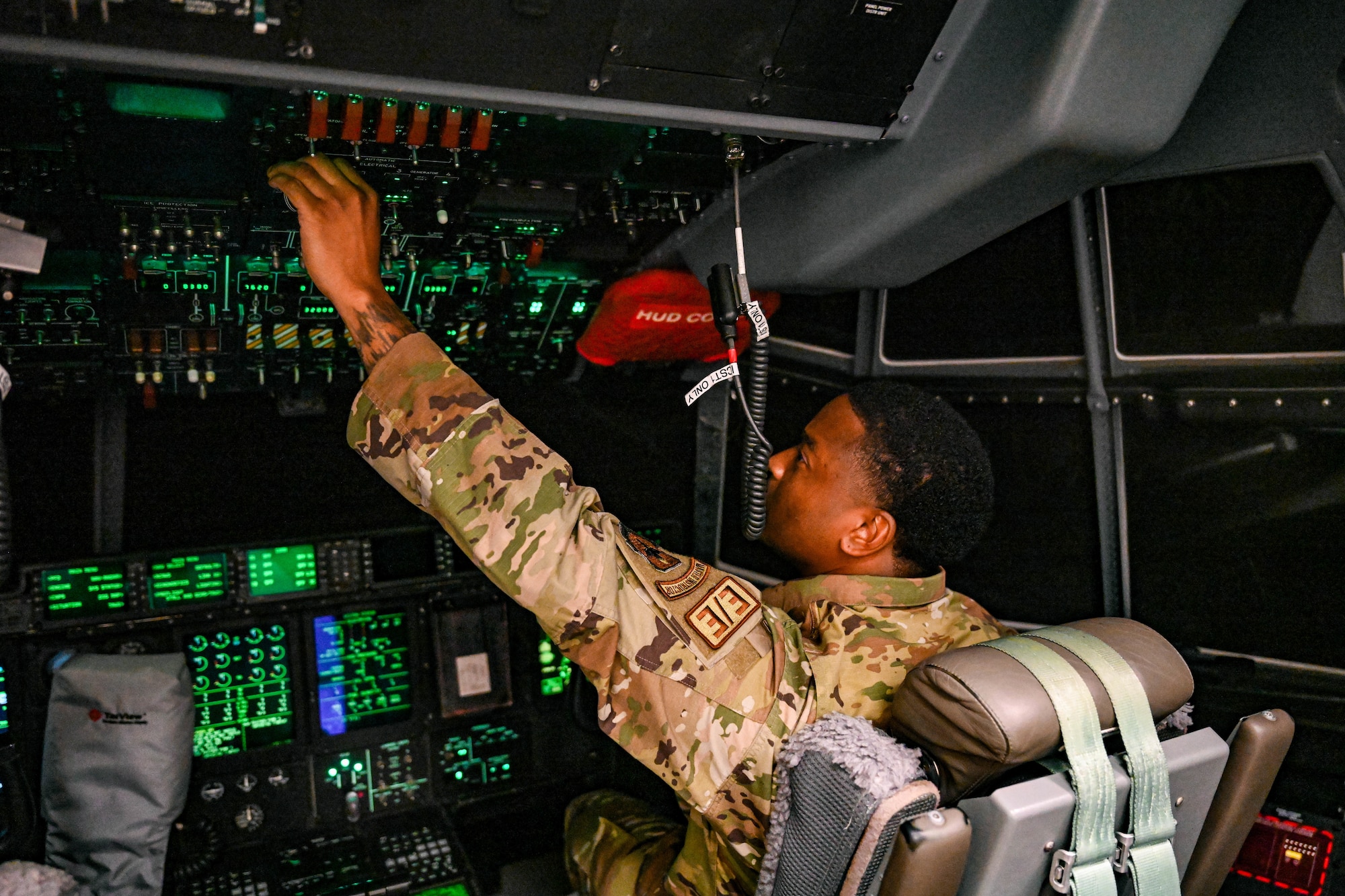 Man pushes buttons in C-130.
