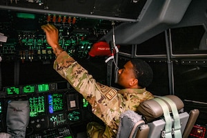 Man pushes buttons in C-130.