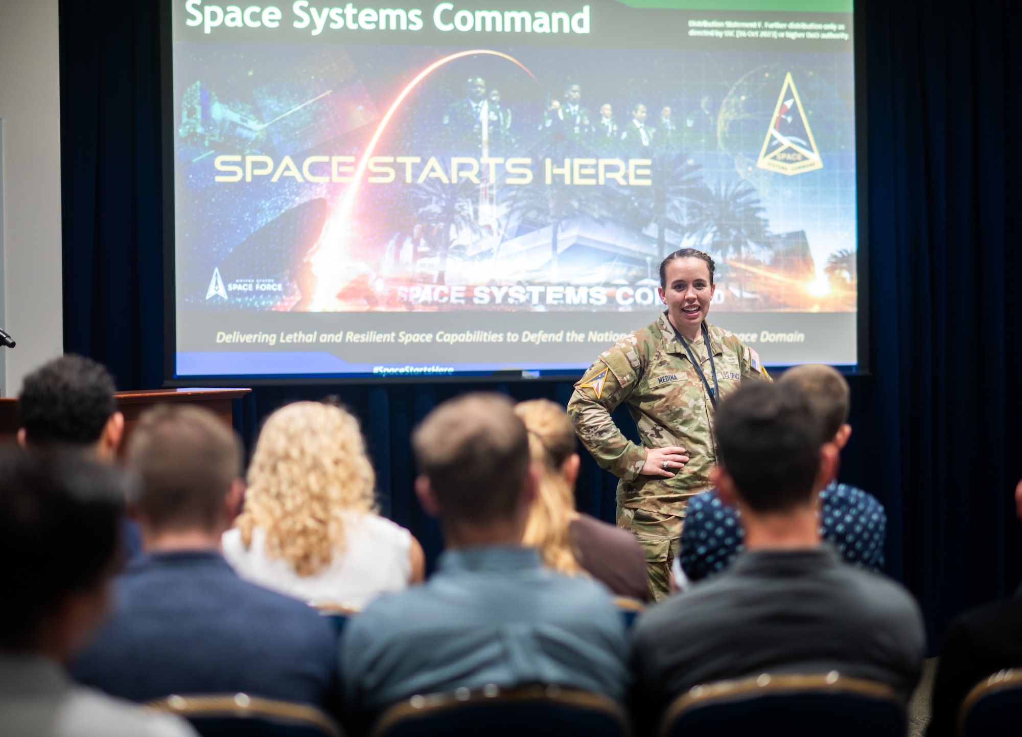 U.S. Space Force Capt. McKenna Medina speaks to a group of visiting cadets from the United States Air Force Academy (USAFA) Cadet Squadron 09 at Los Angeles Air Force Base, April 10, 2026. Capt. Medina, herself a graduate of USAFA, arranged tours and presentations at Space Systems Command (SSC) headquarters to provide future leaders with a deeper understanding of SSC’s mission and its critical role in national defense.