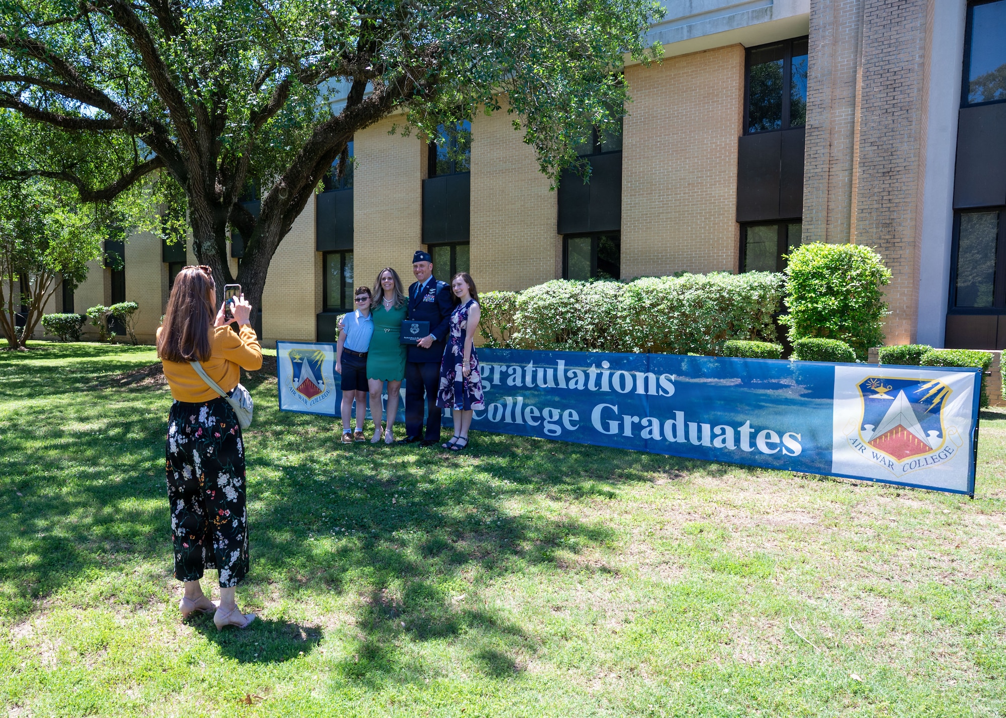 Students from Air War College present a memento from the academic class of 2026 to Brig. Gen. Jocelyn Schermerhorn, AWC commander, during the graduation ceremony for Air War College at Maxwell Air Force Base, Alabama, May 14, 2026. The graduating class consisted of officers from all military branches of the U.S. military, civilian employees of federal government agencies, and officers from international allies and partner nations. (U.S. Air Force photos by Senior Airman Tanner Doerr)