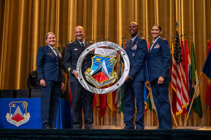 Students from Air War College present a memento from the academic class of 2026 to Brig. Gen. Jocelyn Schermerhorn, AWC commander, during the graduation ceremony for Air War College at Maxwell Air Force Base, Alabama, May 14, 2026. The graduating class consisted of officers from all military branches of the U.S. military, civilian employees of federal government agencies, and officers from international allies and partner nations. (U.S. Air Force photos by Senior Airman Tanner Doerr)