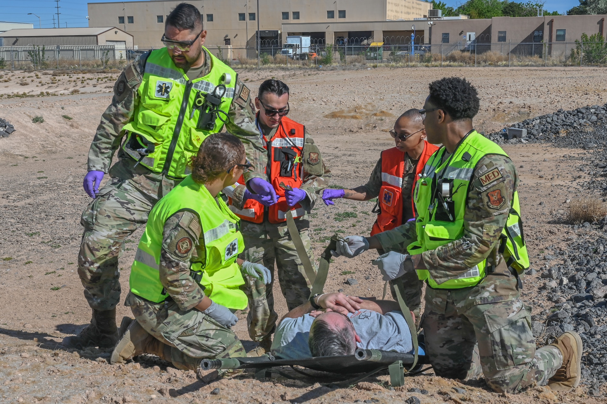Airmen from the 377th Medical Group transfer a simulated patient on a foldable gurney as part of a Sustainment Operations for Air Force Medical Service Response (SOAR) aircraft mishap full-scale exercise at Kirtland Air Force Base