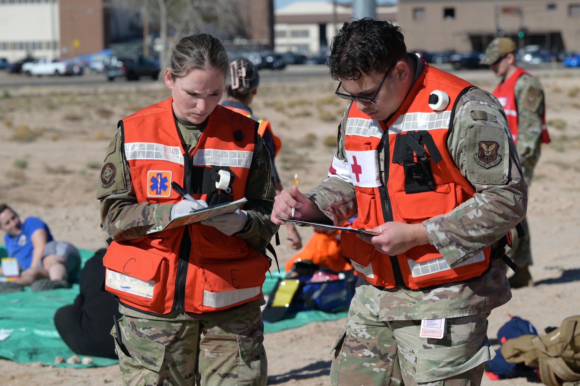 U.S. Air Force 1st Lt. Alianna Kyle, 377th Medical Group clinical nurse, and Airman 1st Class Rodrigo Lara, 377th MDG medical administrative technician, document patient accountability data at a casualty collection point during a full-scale aircraft mishap exercise at Kirtland Air Force Base.