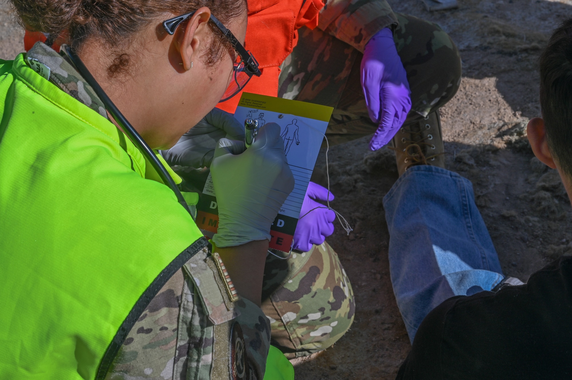 Airman 1st Class Elaine Brito, 377th Medical Group aerospace medical service specialist, documents the injuries and status of a simulated patient as part of a Sustainment Operations for Air Force Medical Service Response (SOAR) aircraft mishap full-scale exercise at Kirtland Air Force Base.