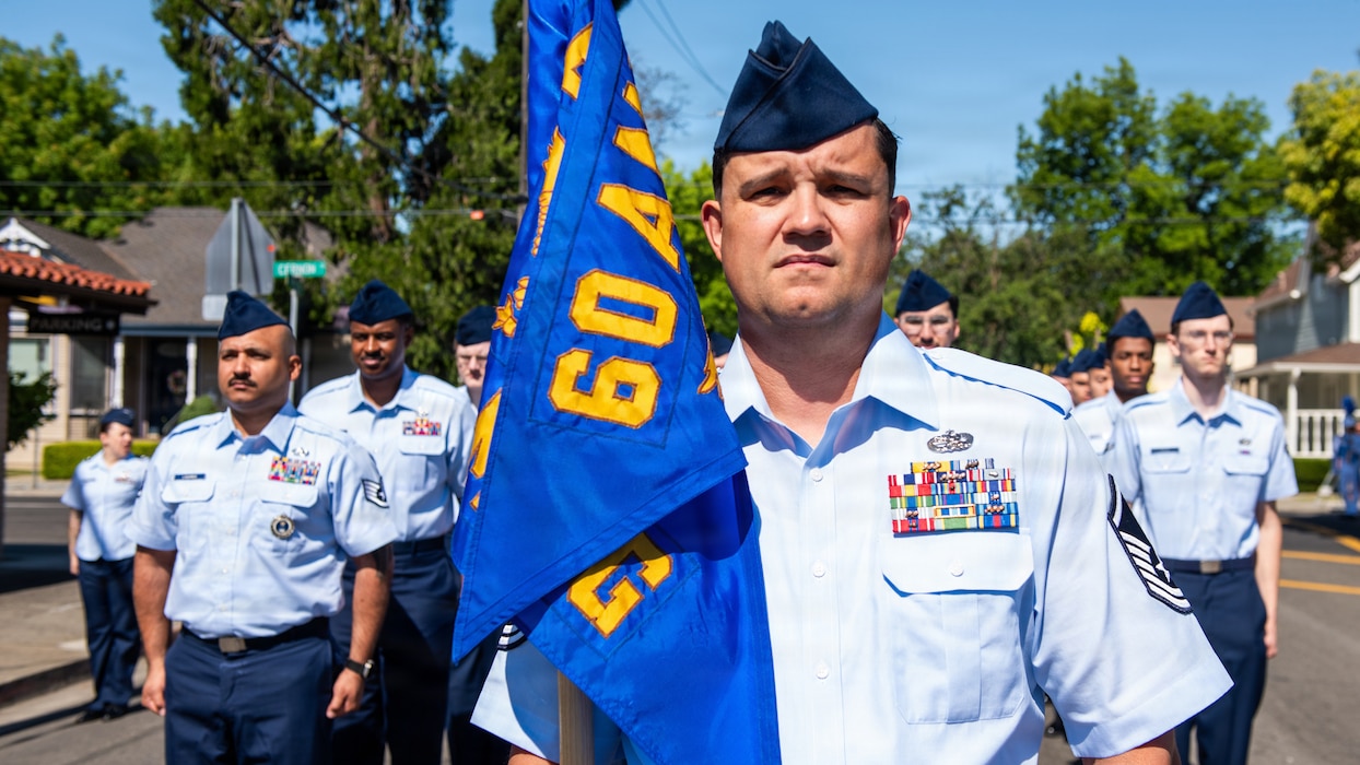 Airman stands in front of formation for parade