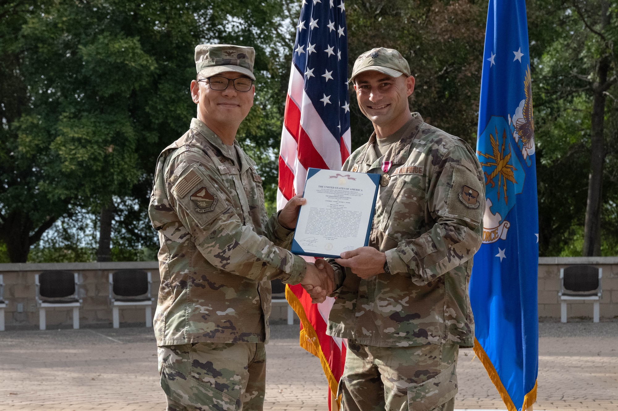 U.S. Air Force Col. Peter Joo, 47th Mission Support Group commander, left, presents Lt. Col. Matthew Thorne, outgoing 47th Contracting Squadron (CONS) commander, with a certificate for the Meritorious Service Medal during the 47th CONS change of command ceremony at Laughlin Air Force Base, Texas, May 27, 2026. The certificate recognized Thorne’s achievements during his tenure as 47th CONS commander. (U.S. Air Force photo by Airman 1st Class Darryl Keith)