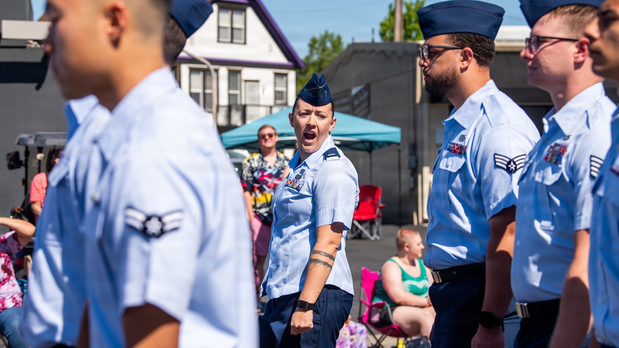 Officer leads Airmen marching in formation in parade