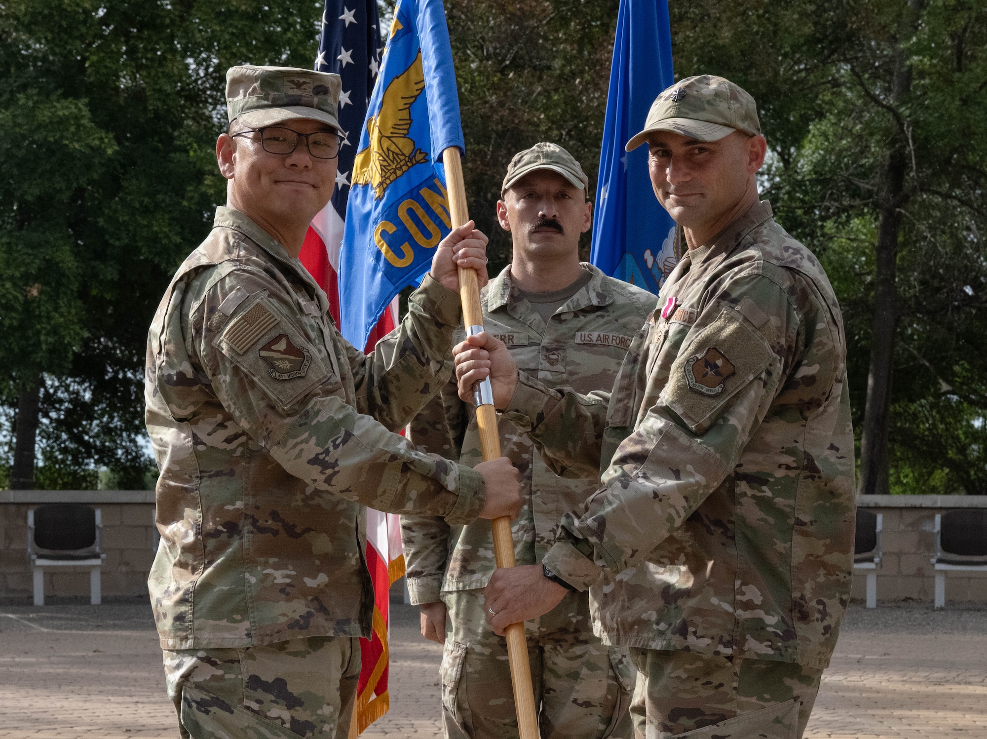 U.S. Air Force Col. Peter Joo, 47th Mission Support Group commander, left, receives the squadron guidon from Lt. Col. Matthew Thorne, 47th Contracting Squadron (CONS) outgoing commander, during the 47th CONS change of command ceremony at Laughlin Air Force Base, Texas, May 27, 2026. In a change of command ceremony, the guidon symbolizes the transfer of command, as well as the authority and responsibility associated with it. (U.S. Air Force photo by Airman 1st Class Darryl Keith)