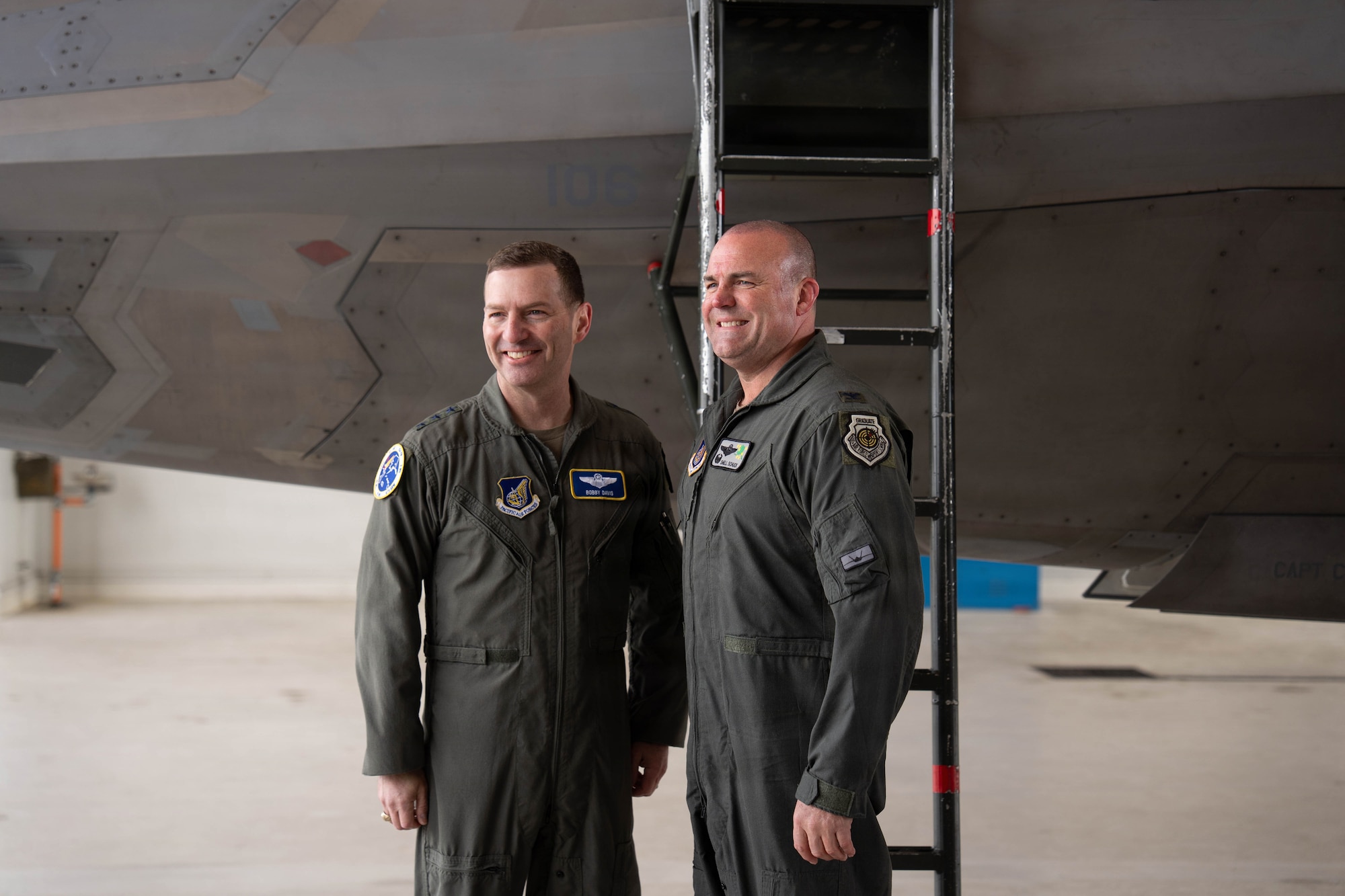 U.S. Air Force Col. Charles Schuck, 3rd Wing commander, right, poses with Lt. Gen. Robert Davis, Alaska NORAD Region, Alaska Command, and 11th Air Force commander, in front of an F-22 Raptor aircraft following Schuck's fini-flight on Joint Base Elmendorf-Richardson, Alaska, May, 26, 2026. The final flight or "fini-flight," is a time-honored Air Force tradition that tracks back to World War II, serving as a formal celebration of a pilot's total flying hours and operational legacy as they prepare for a permanent change of station or retirement. (U.S. Air Force photo by Airman 1st Class Keola Vischi)