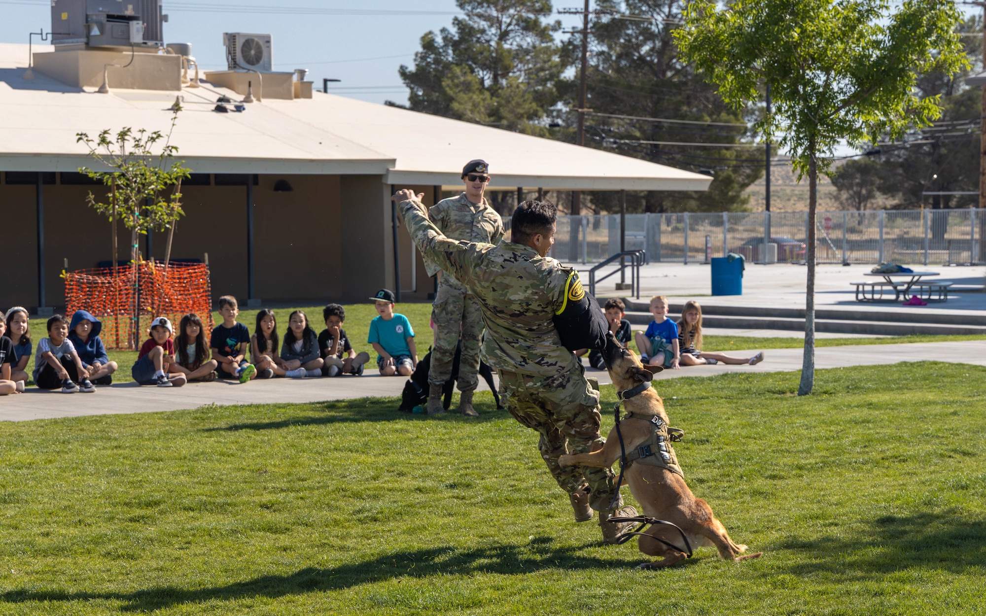 Airmen from the 412th Security Forces Squadron provide a military working dog demonstration for school children during Police Week 2026, at Edwards Air Force Base, California, May 12, 2026. (Air Force photo by Lindsey Gordon)