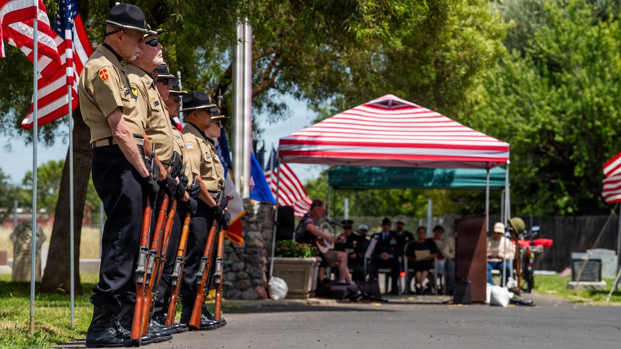 Honor guard members stand by to render rifle salute