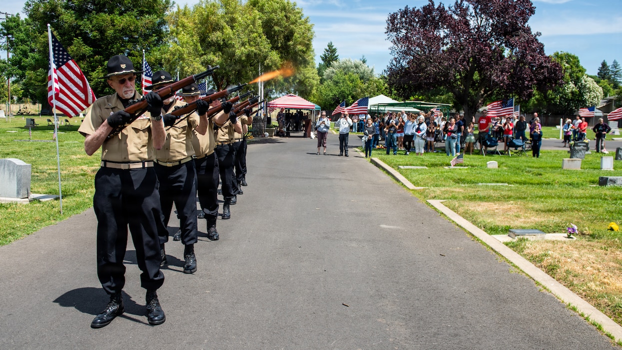 Honor guard members render rifle salute