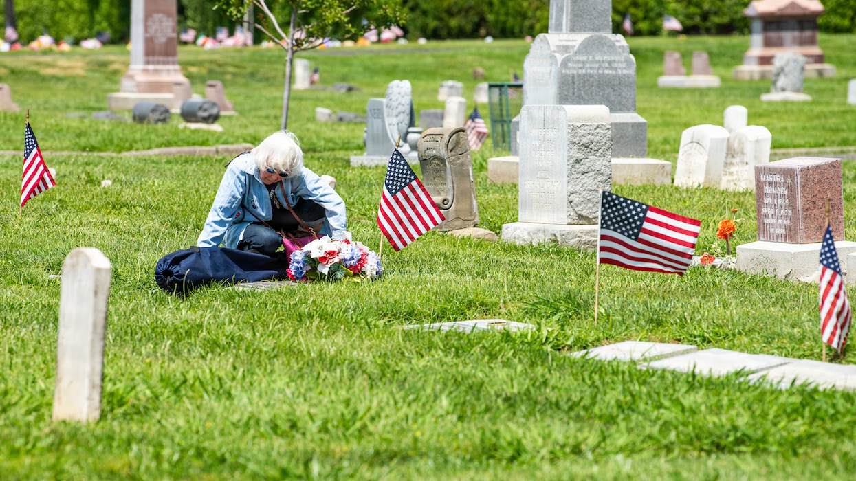 Family member visits the gravesite of a former service member