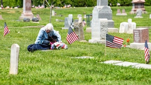 Family member visits the gravesite of a former service member