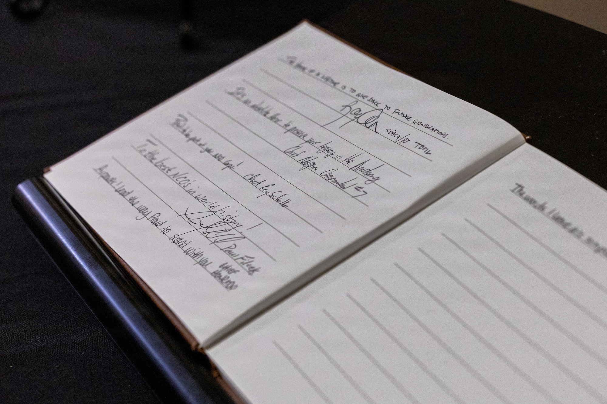 A guest book sits open for visitors to sign outside the Colón‑López Noncommissioned Officer Academy Auditorium at Sheppard Air Force Base, Texas, May 27, 2026.
