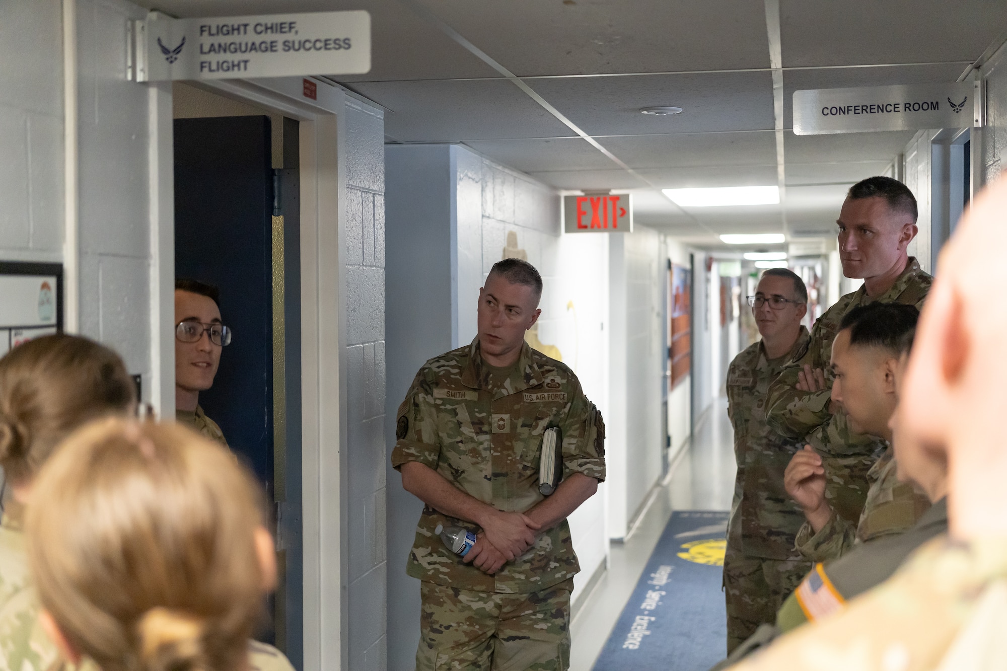 Chief Master Sgt. Tyler Smith, intelligence career field manager (center), listens to a brief from MSgt Cameron Kline, Language Success Flight Chief at the 314th Training Squadron, Presidio of Monterey, May 12, 2026.