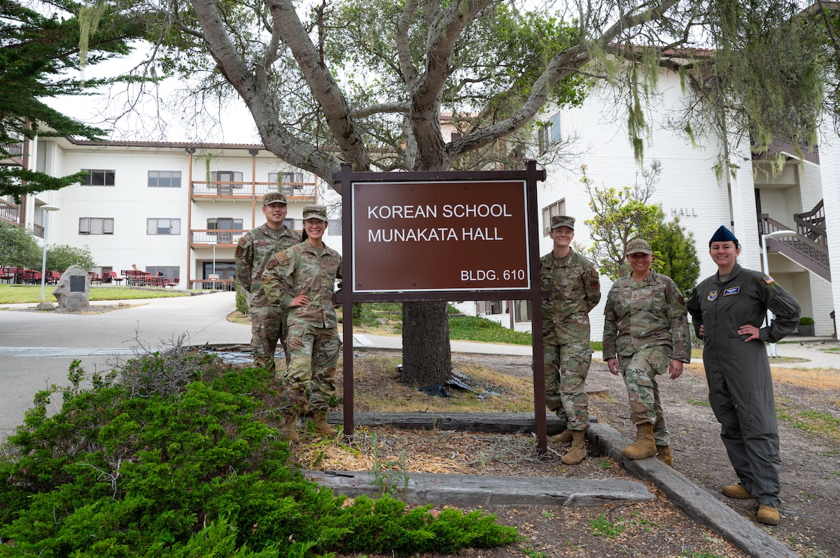 Members of the U.S. Air Force intelligence career field management team and 517th Training Group military language instructors pose beside the Korean schoolhouse at DLIFLC, Presidio of Monterey, Calif., May 12, 2026.