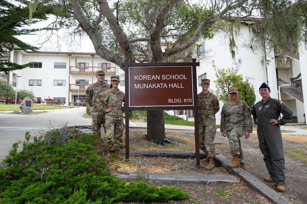 Members of the U.S. Air Force intelligence career field management team and 517th Training Group military language instructors pose beside the Korean schoolhouse at DLIFLC, Presidio of Monterey, Calif., May 12, 2026.