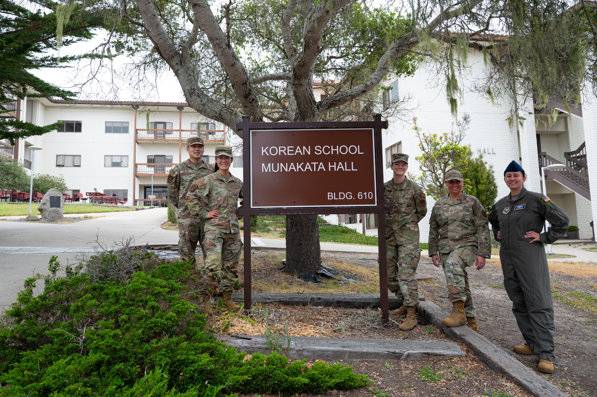 Members of the U.S. Air Force intelligence career field management team and 517th Training Group military language instructors pose beside the Korean schoolhouse at DLIFLC, Presidio of Monterey, Calif., May 12, 2026.