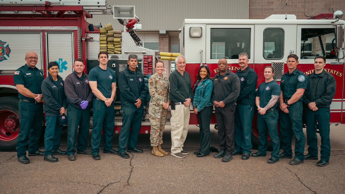 firefighters stand and pose for a group photo
