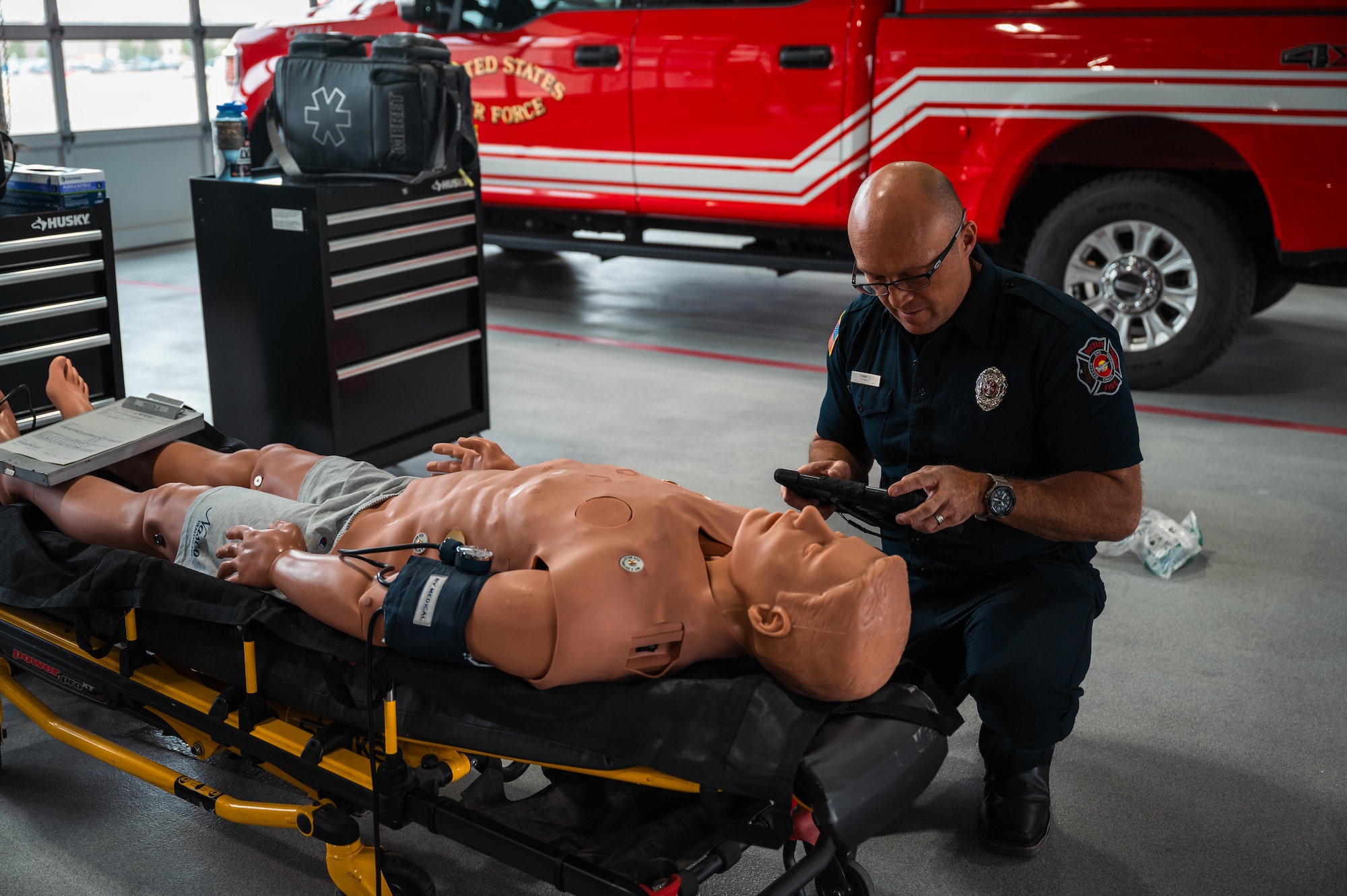 firefighter calibrates a trauma mannequin