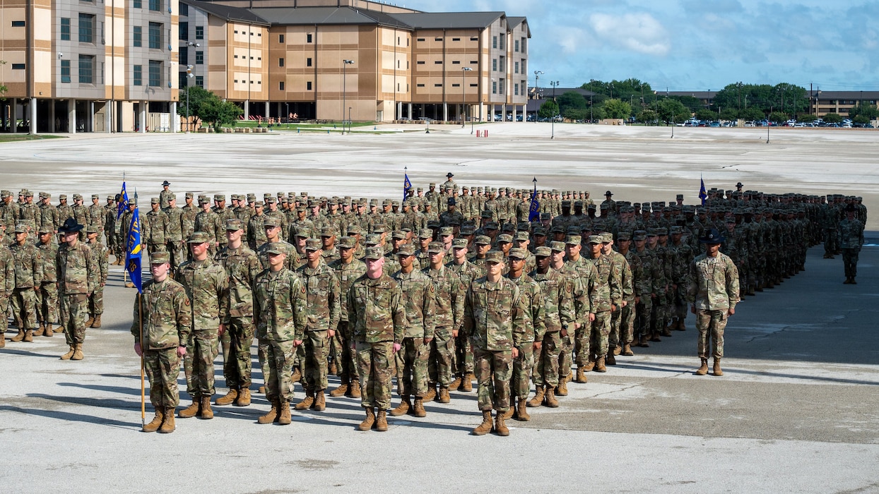 Air Force trainees stand in formation during graduation