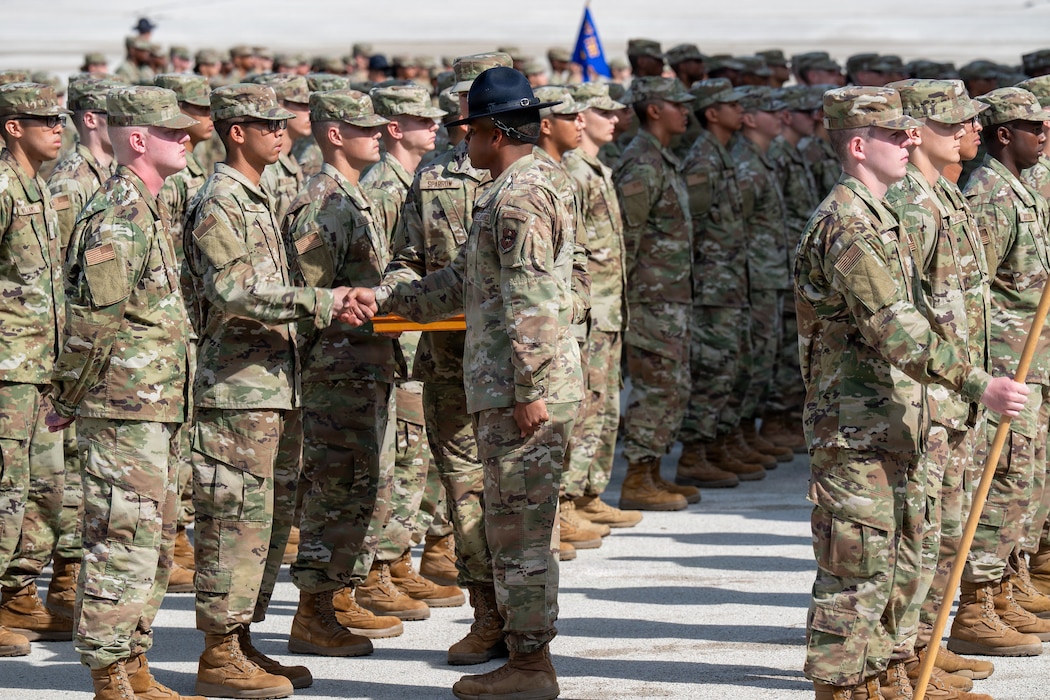 Military instructor congratulates trainee