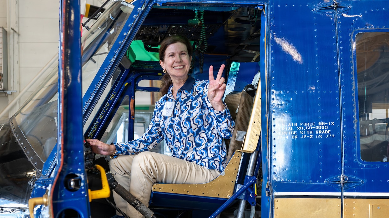 Civic leader poses for photo in aircraft cockpit