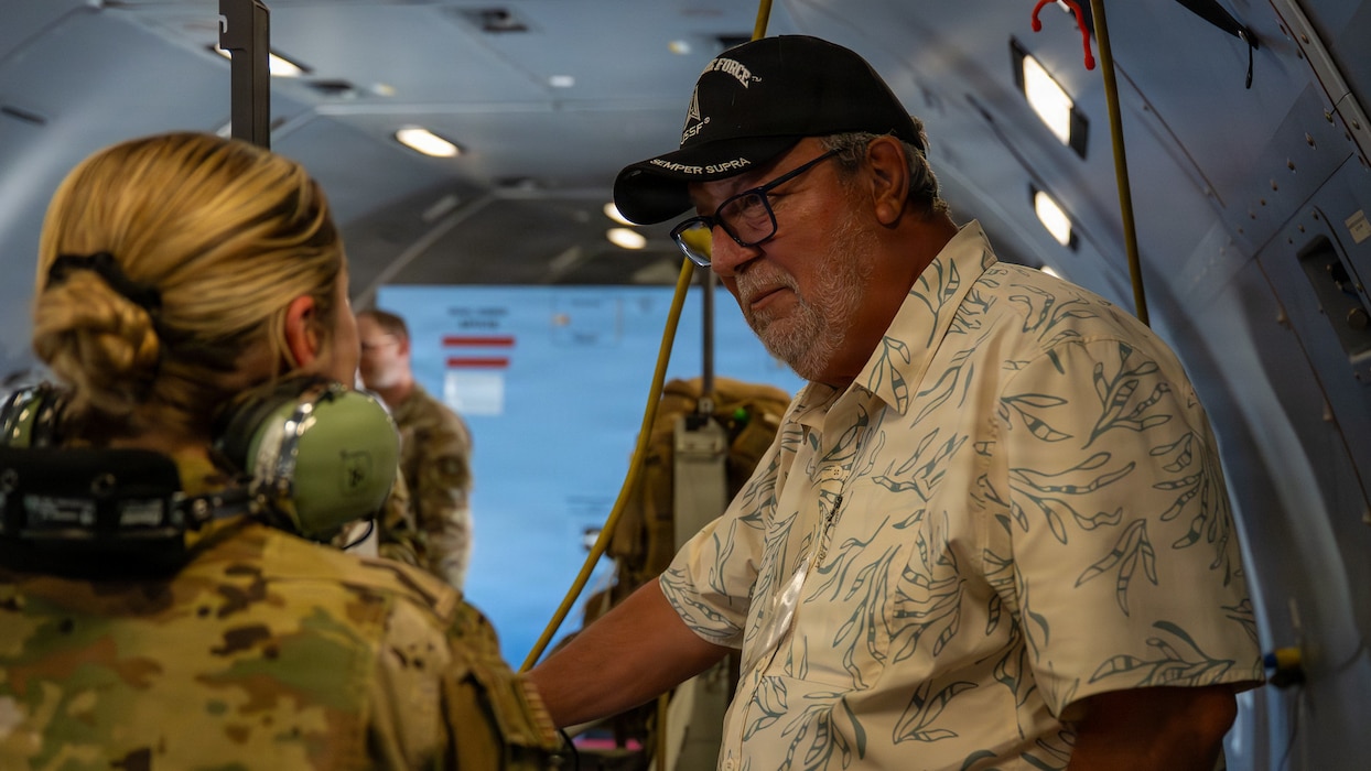 Civic leader and Airman chatting on aircraft