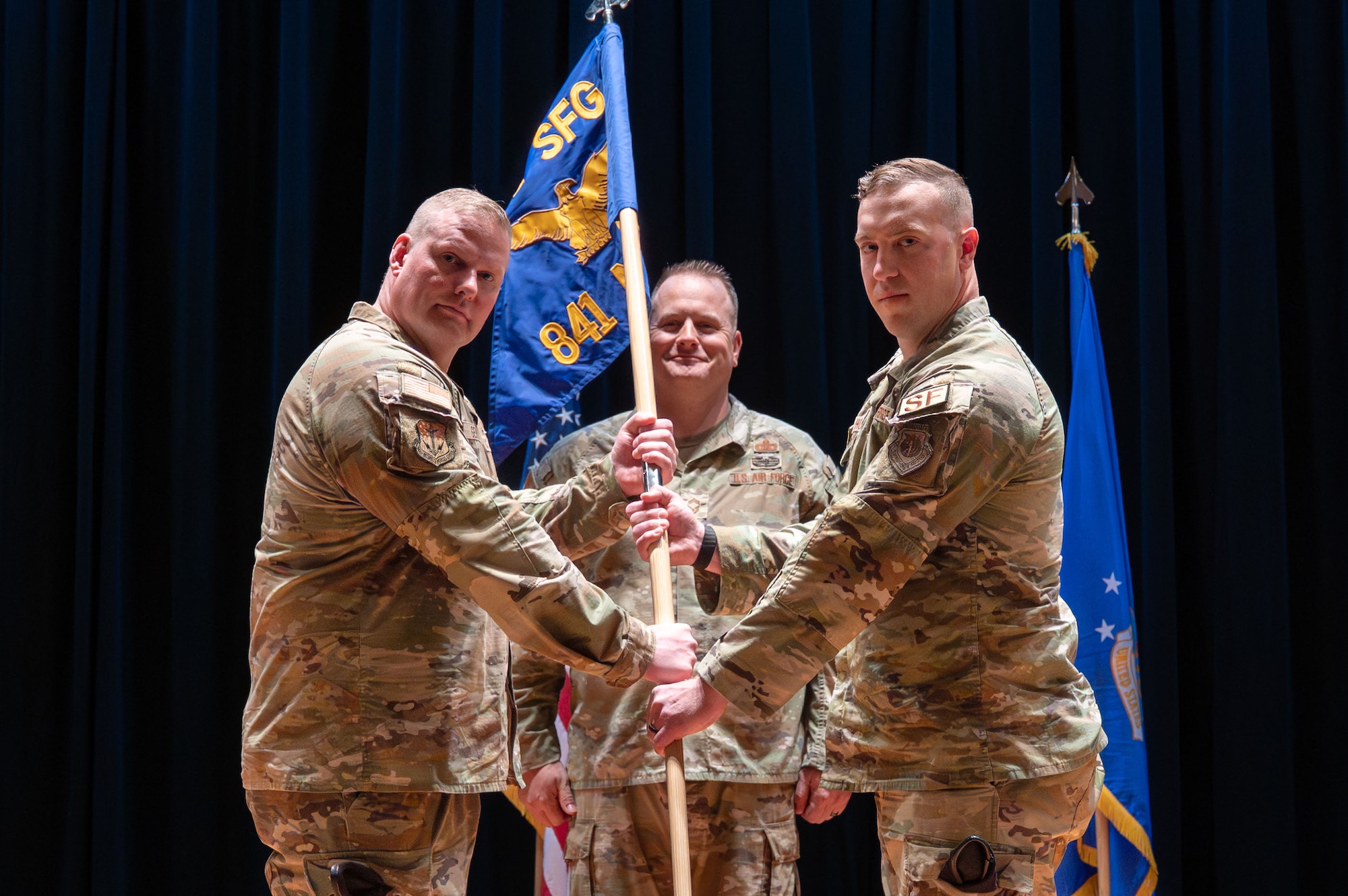 U.S. Air Force Capt. Colin Hoveln, right, accepts command of the 841st Missile Security Forces Squadron from Col. Drew Gehler, 341st Security Forces Group commander, during a change of command ceremony at Malmstrom AFB, Montana.