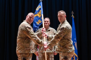 U.S. Air Force Capt. Colin Hoveln, right, accepts command of the 841st Missile Security Forces Squadron from Col. Drew Gehler, 341st Security Forces Group commander, during a change of command ceremony at Malmstrom AFB, Montana.