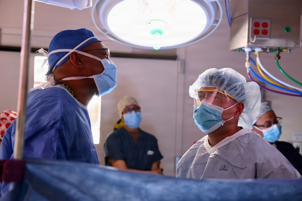 Cmdr. Harold Barnes (left), director of surgical services at Naval Hospital Twentynine Palms, and Sgt. 1st Class Norris R. Sayviseth, noncommissioned officer-in-charge of surgical services at Weed Army Community Hospital, perform surgery at Robert E. Bush Naval Hospital in May 2026. Sayviseth participated in the Joint Medical Augmentation and Skills Training Program, a partnership between Naval Hospital Twentynine Palms and Weed Army Community Hospital designed to strengthen joint medical readiness, interoperability, and clinical skills sustainment across the Military Health System. (U.S. Navy photo by Christopher Jones, NMRTC/NH Twentynine Palms public affairs officer)