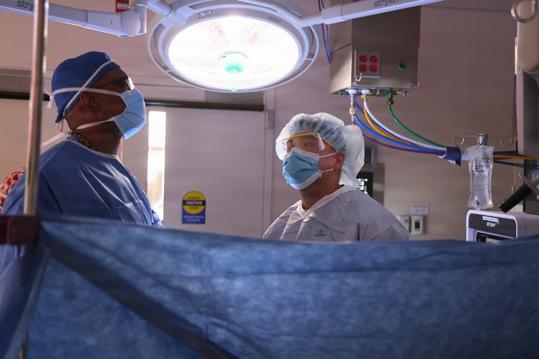 Cmdr. Harold Barnes (left), director of surgical services at Naval Hospital Twentynine Palms, and Sgt. 1st Class Norris R. Sayviseth, noncommissioned officer-in-charge of surgical services at Weed Army Community Hospital, perform surgery at Robert E. Bush Naval Hospital in May 2026. Sayviseth participated in the Joint Medical Augmentation and Skills Training Program, a partnership between Naval Hospital Twentynine Palms and Weed Army Community Hospital designed to strengthen joint medical readiness, interoperability, and clinical skills sustainment across the Military Health System. (U.S. Navy photo by Christopher Jones, NMRTC/NH Twentynine Palms public affairs officer)