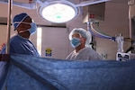 Cmdr. Harold Barnes (left), director of surgical services at Naval Hospital Twentynine Palms, and Sgt. 1st Class Norris R. Sayviseth, noncommissioned officer-in-charge of surgical services at Weed Army Community Hospital, perform surgery at Robert E. Bush Naval Hospital in May 2026. Sayviseth participated in the Joint Medical Augmentation and Skills Training Program, a partnership between Naval Hospital Twentynine Palms and Weed Army Community Hospital designed to strengthen joint medical readiness, interoperability, and clinical skills sustainment across the Military Health System. (U.S. Navy photo by Christopher Jones, NMRTC/NH Twentynine Palms public affairs officer)