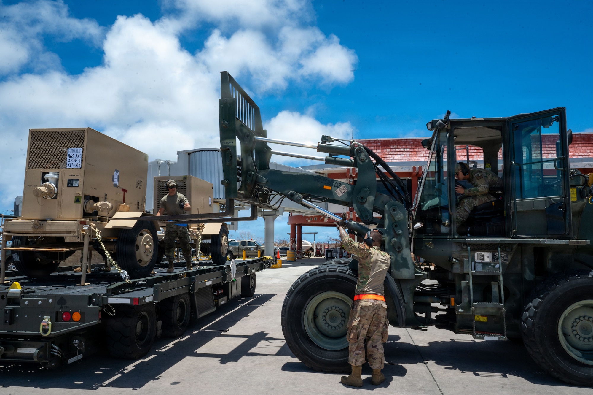 U.S. Airmen assigned to the 36th Contingency Response Squadron offload a diesel powered water pump from a K-loader at Saipan International Airport, Saipan, Commonwealth of the Northern Mariana Islands, April 27, 2026. The water pump draws raw water to a Reverse Osmosis Water Purification Unit that is deployed in support of bringing usable water to Saipan residents through a series of filtration processes. All support efforts are conducted in close coordination with local, territorial and federal partners to ensure a unified and efficient response to Typhoon Sinlaku disaster relief. (U.S. Air Force photo by Senior Airman Manasseh Demissie)