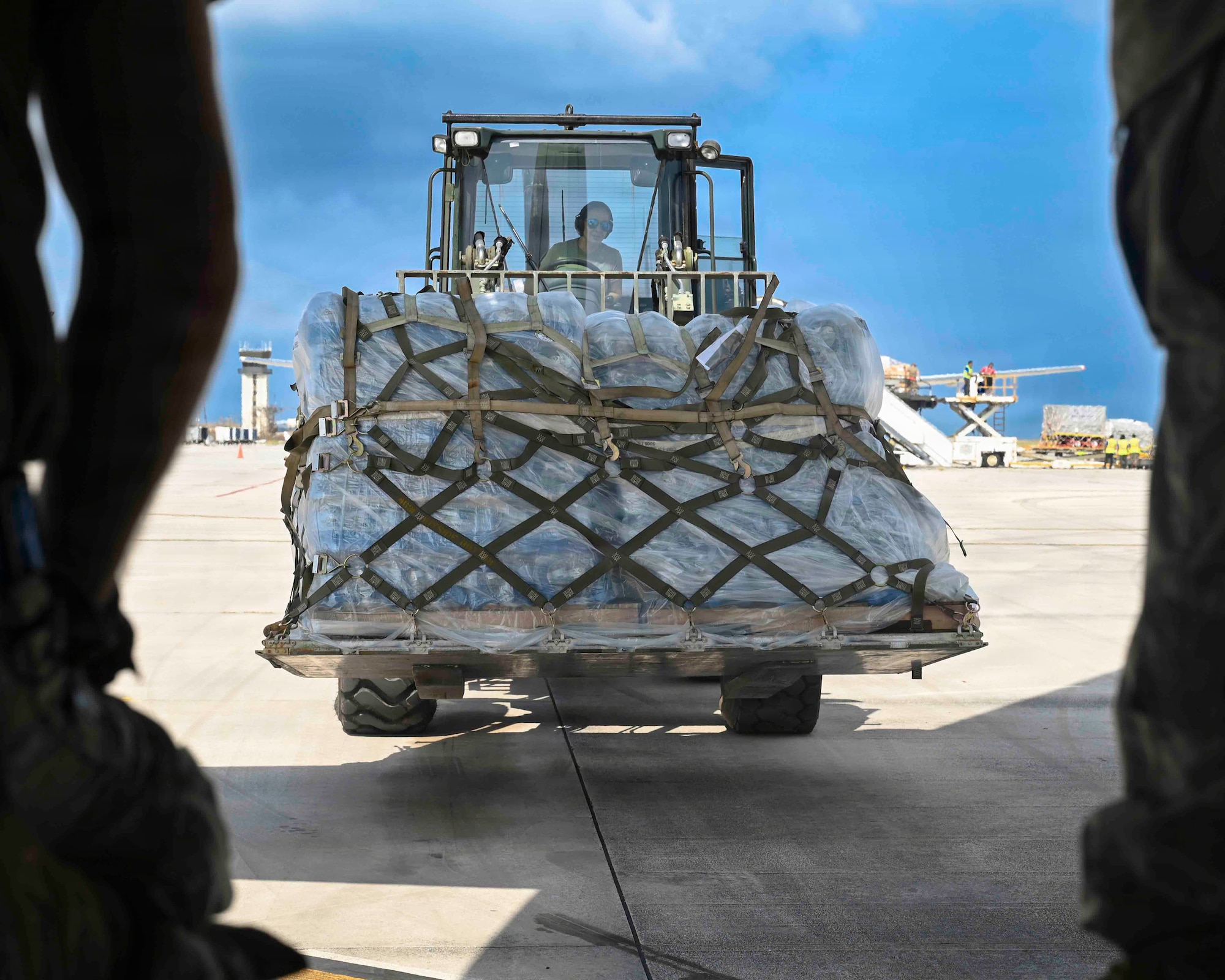 U.S. Air Force Senior Airman Lilian Perez, 36th Contingency Response Squadron aerial port journeyman, operates a 10K forklift to unload supplies at Saipan International Airport, Saipan,Northern Marianas Islands, April 19, 2026. The delivery supports humanitarian efforts for islands impacted by Super Typhoon Sinlaku. (U.S. Air Force by Senior Airman Joseph Maye)