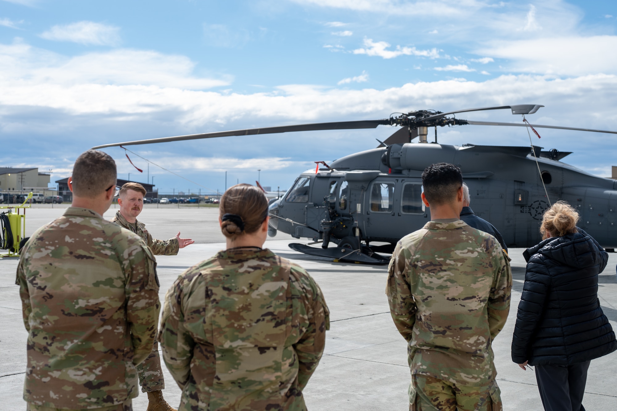 U.S. Air Force Master Sgt. Garrett Bader, the propulsion superintendent assigned to the 176th Maintenance Squadron, reviews the search and rescue mission of the HH-60G Pave Hawk helicopter with a Gold Star family at Joint Base Elmendorf-Richardson, Alaska, May 21, 2026. Bader detailed how the unit utilizes the aircraft for combat search and rescue, medical evacuations and civil search operations across Alaska's rugged terrain. This joint-base event brought together Army and Air Force personnel to offer support, fellowship and technical insight to families of fallen service members. (U.S. Air Force photo by Airman 1st Class Theodore Gowdy)